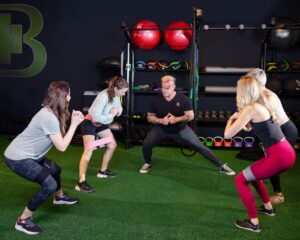 Coach leading a small group training session on the turf at Bodystyle Fitness in Clearwater FL