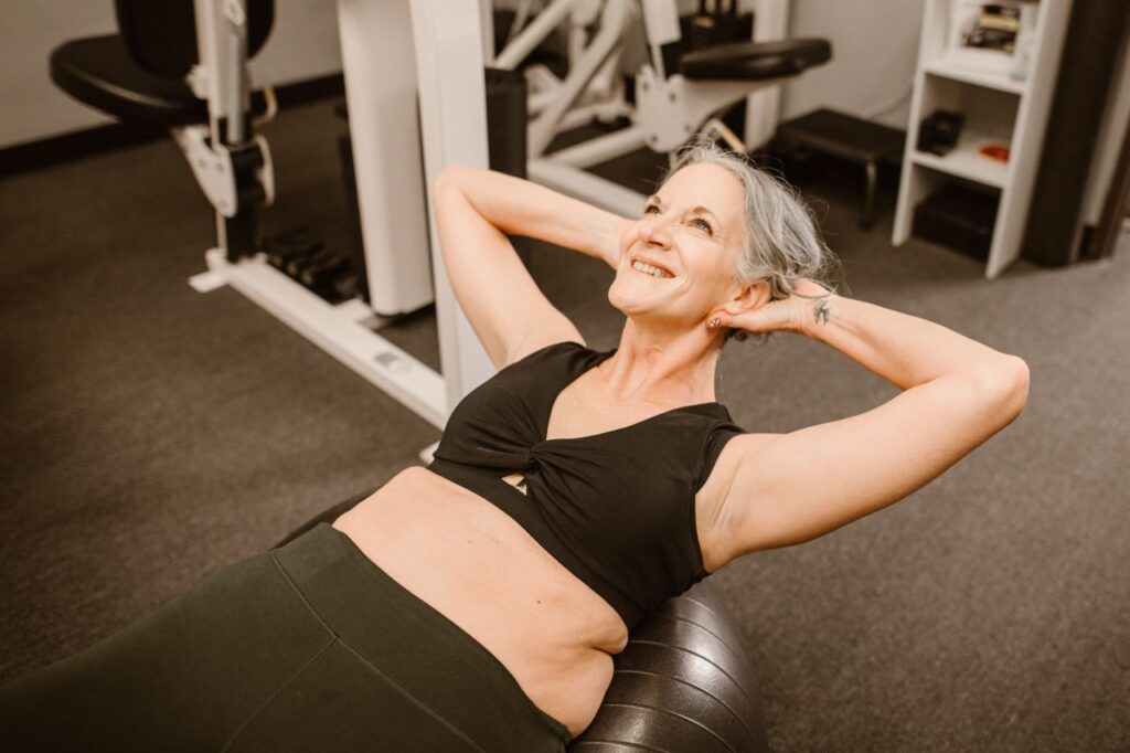 Smiling woman over 40 exercising during a strength workout